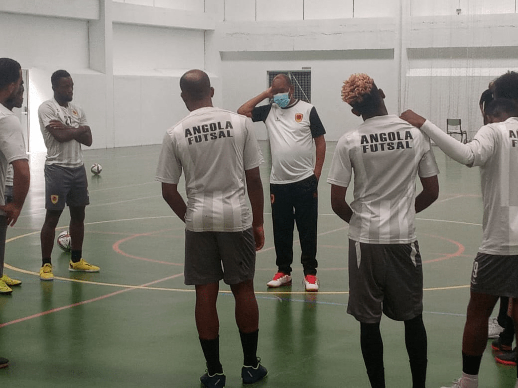 Le sélectionneur de l'Angola, Rui Sampaio (avec le masque), à l'entraînement avec ses joueurs.